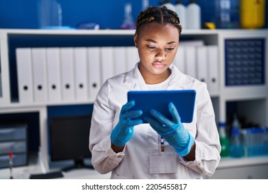 African American Woman Scientist Using Touchpad At Laboratory