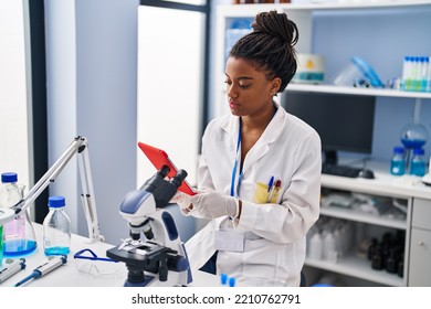 African American Woman Scientist Using Touchpad Working At Laboratory