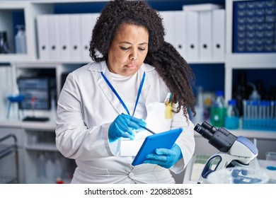 African American Woman Scientist Writing On Touchpad At Laboratory