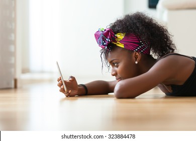 African American woman sending a text message on a mobile phone - Black people - Shutterstock ID 323884478