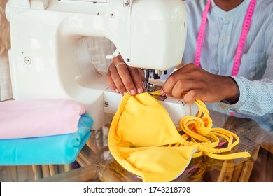 African American Woman Sewing A Stylish Yellow Swimming Suit For Summer Pool Party In Tropical Workshop In Bali