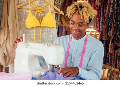 African American Woman Sewing A Stylish Yellow Swimming Suit For Summer Pool Party In Tropical Workshop In Bali