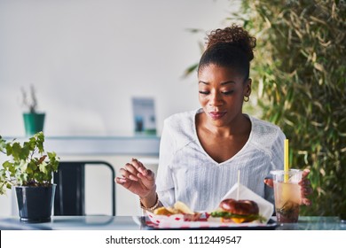 African American Woman Sitting Down To Enjoy Healthy Vegan Fast Food