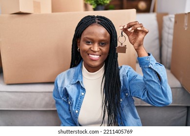 African american woman smiling confident holding key at new home - Powered by Shutterstock