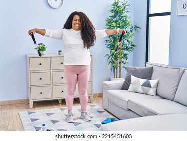 African American Woman Smiling Confident Using Elastic Band Training At Home
