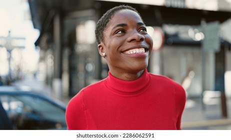 African american woman smiling confident looking to the sky at street - Shutterstock ID 2286062591