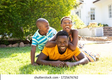 African American woman spending time with her partner and their son, lying on a lawn in the garden. . Social distancing and self isolation in quarantine lockdown for Coronavirus Covid19
 - Powered by Shutterstock