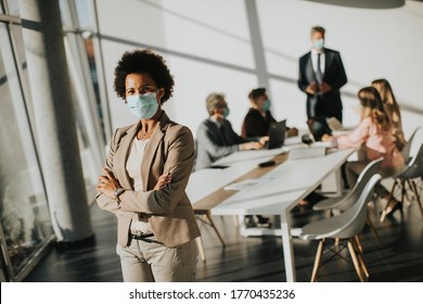 African American Woman Standing In The Office And Wear Mask As Protection From Corona Virus