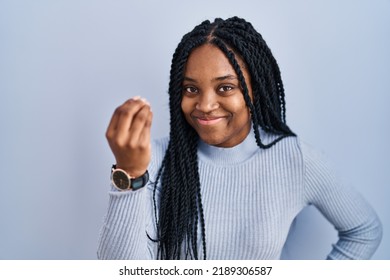 African American Woman Standing Over Blue Background Doing Italian Gesture With Hand And Fingers Confident Expression 