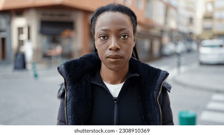 African american woman standing with serious expression at street - Shutterstock ID 2308910369