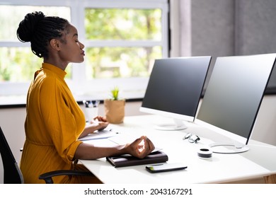 African American Woman Stress Management. Meditating Near Computer - Powered by Shutterstock