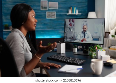 African American Woman Talking To Medic On Video Call To Receive Medical Advice About Telemedicine And Telehealth At Home. Young Patient Using Online Remote Conference To Talk To Physician