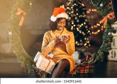 African American Woman Talking On Phone On Christmas