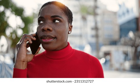 African american woman talking on smartphone with serious expression at street - Shutterstock ID 2311312727