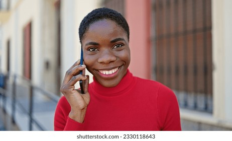 African american woman talking on smartphone smiling at street - Shutterstock ID 2330118643