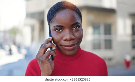 African american woman talking on smartphone smiling at street - Shutterstock ID 2361520885