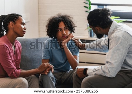 African American woman with a teen son has a meeting with a psychologist. A psychotherapist session with a patient. mother seeks professional help for her teenage son