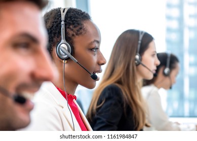 African American Woman Telemarketing Customer Service Staff Working With Diverse Team In Call Center Office