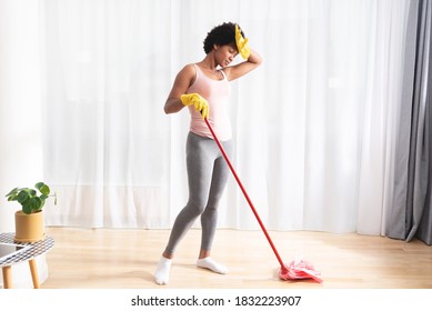 African American Woman Tired By Mopping The House