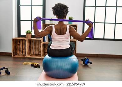 African American Woman Using Elastic Band Training At Home