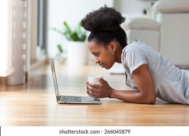 African American woman using a laptop in her living room