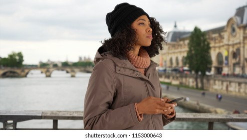 African American Woman Using Smartphone To Check Direction While In Paris