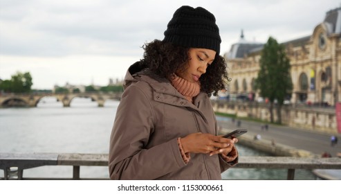 African American Woman Using Smartphone To Check Direction While In Paris