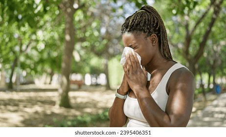 African american woman using tissue with pollen allergy at park - Powered by Shutterstock