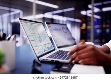 African American woman using virtual dashboard to predict emerging market trends in financial analytics for her business. - Powered by Shutterstock