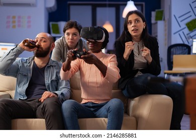 African American Woman Using Vr Glasses And Playing Video Games At Office Party With Drinks After Work Hours. Colleagues Having Fun With Virtual Reality Headset At Celebration.