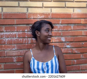 African American Woman Walking Along The Train Tracks In A Rural Location.