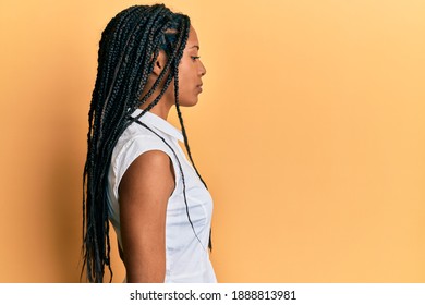 African american woman wearing casual clothes looking to side, relax profile pose with natural face with confident smile.  - Powered by Shutterstock