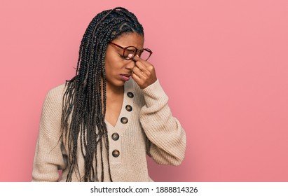 African american woman wearing casual clothes tired rubbing nose and eyes feeling fatigue and headache. stress and frustration concept.  - Shutterstock ID 1888814326