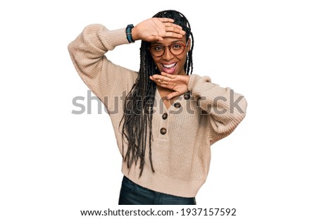 African american woman wearing casual clothes smiling cheerful playing peek a boo with hands showing face. surprised and exited 