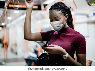 African American Woman Wearing Mask On The Bus While Using Public Transportation In The New Normal