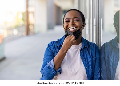 African American woman wearing protective mask while standing with arms crossed at the airport during virus epidemic. African american young woman wearing face protective medical mask for protection - Powered by Shutterstock