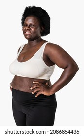 African American woman wearing sports bra and black yoga pants with confidence