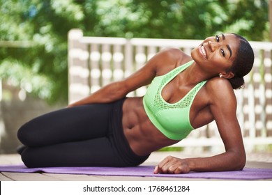 African American Woman Wearing Workout Clothes Posing On Backyard Deck