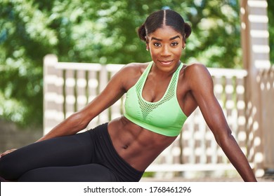 African American Woman Wearing Workout Clothes Posing On Backyard Deck