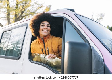 African American Woman In The Window Of A Camper Van Traveling