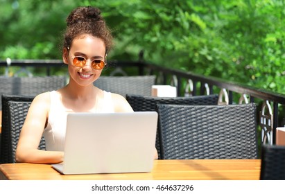 African American Woman Working On Laptop Outdoor