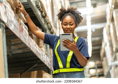 African American Woman Working With A Tablet Walks Through The Warehouse To Check Inventories And Attach A Barcode To Deliver Logistics To Customers In A Warehouse.