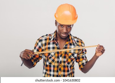 African American worker builder uses a measuring tape - Powered by Shutterstock