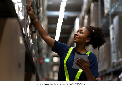 African American worker checking the stock on shelf in warehouse comparing the balancing number in system after delivery shipment. Using tablet to update online stock available for selling on website - Powered by Shutterstock