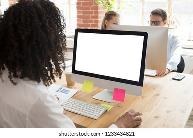 African American Worker Using Computer At Workplace, Looking At White Screen Mock Up, Female Employee Writing, Reading Business Email, Doing Office Work, Colleagues Talking In Background