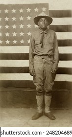 African American World War 1 Soldier. 1917-18. Portrait May Depict A Man Named Eugene Jones, Standing In Front Of A U.S. American Flag. Ca. 1917-1918.