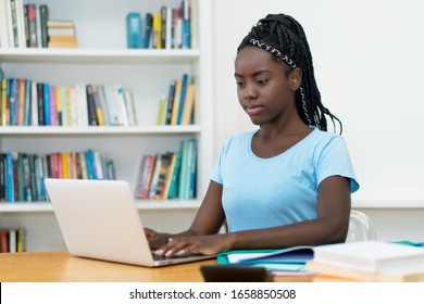 African American Young Adult Female Student At Computer At University