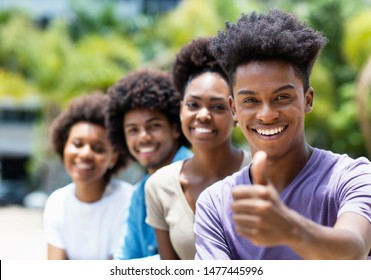 African American Young Adult Man With Friends Showing Thumb Up Outdoor In City In Summer