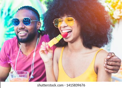 African American Young Couple Eating Fruit And Drinking Cocktails - Summer Party With Friends And Healthy Food Concept