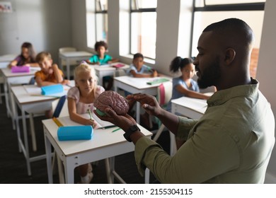 African american young male teacher explaining brain model to multiracial elementary students. unaltered, education, learning, childhood, occupation, teaching, science and school concept. - Powered by Shutterstock